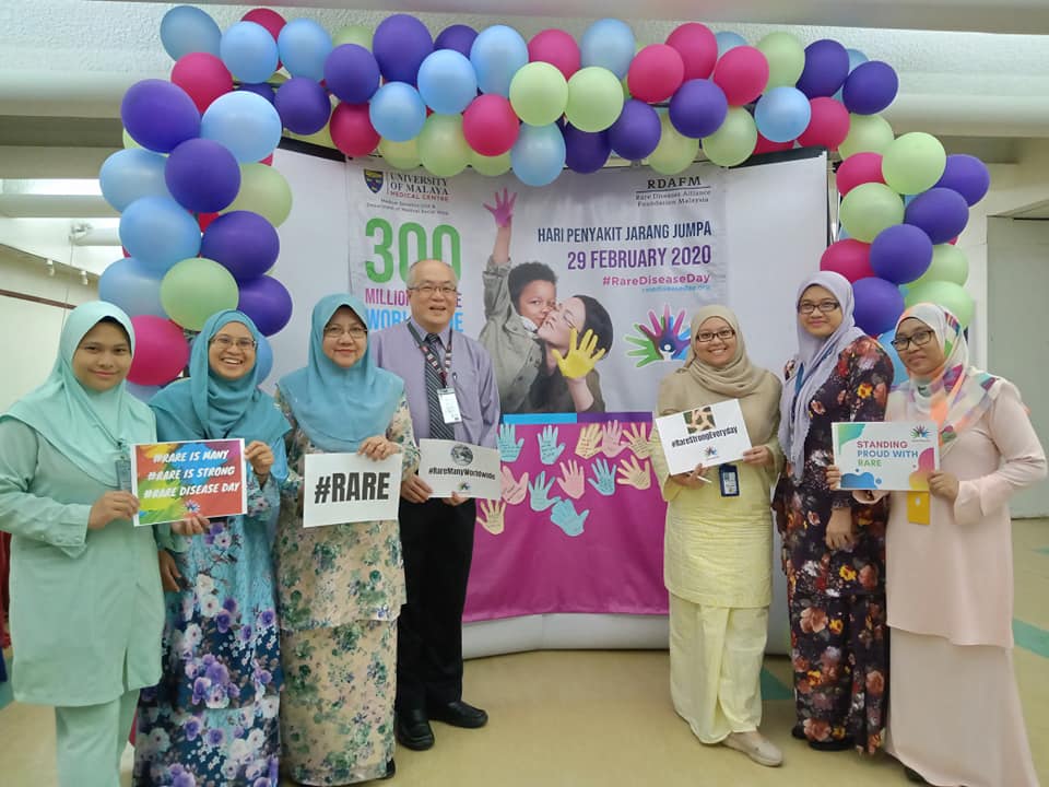 An image of people standing with different posters for Rare Disease Day 2020.