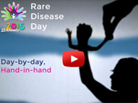 A screenshot of the Rare Disease Day 2015 video, The text reads, 'day-by-day, hand-in-hand'.