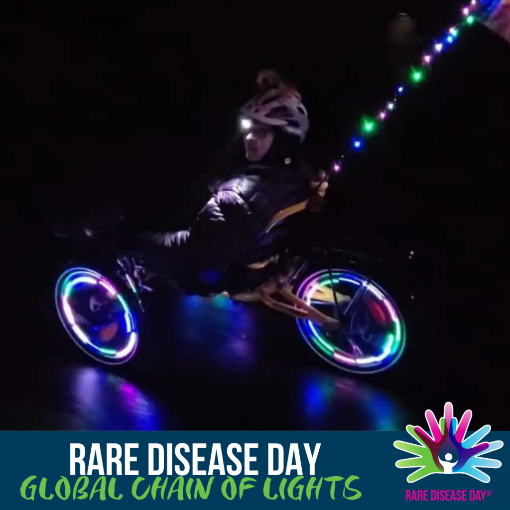An image which shows someone riding a bicycle with the wheels lit up. The text reads, 'Rare Disease Day Global Chain of lights'.