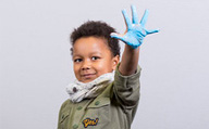 An image of Gauthier with his palm held out and painted blue.