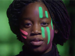 An image of a girl from the rare disease day video with bright pink, green and purple paint on her face.