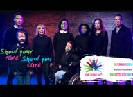A rare disease day 2019 poster. It features different people all dressed in black and the text reads, 'Show your rare, Show you care'.